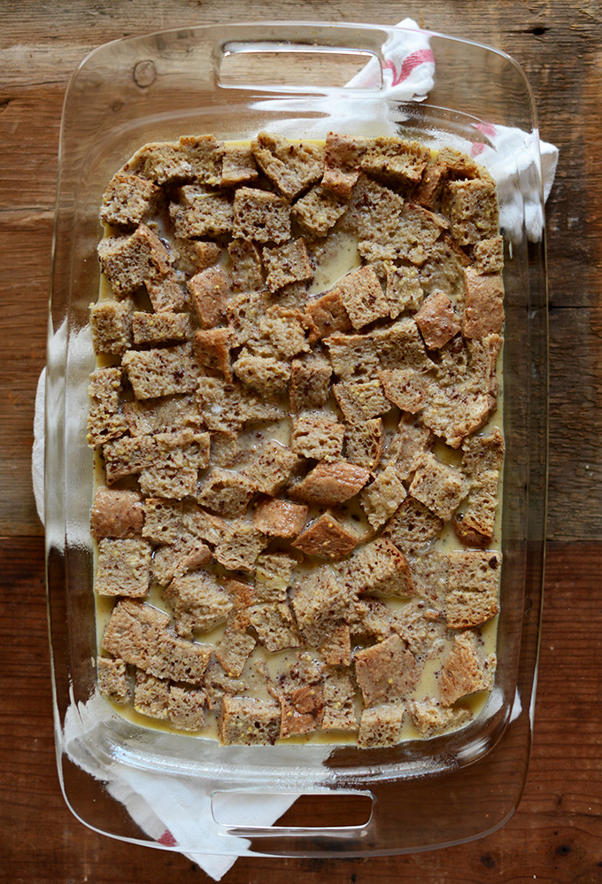 Cubed whole grain bread and egg mixture in a baking pan