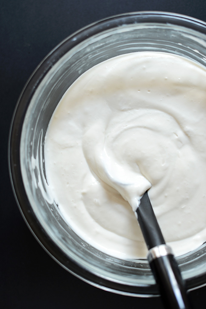 Using a rubber spatula to fold together ingredients for Dairy-Free Cream Cheese Filling