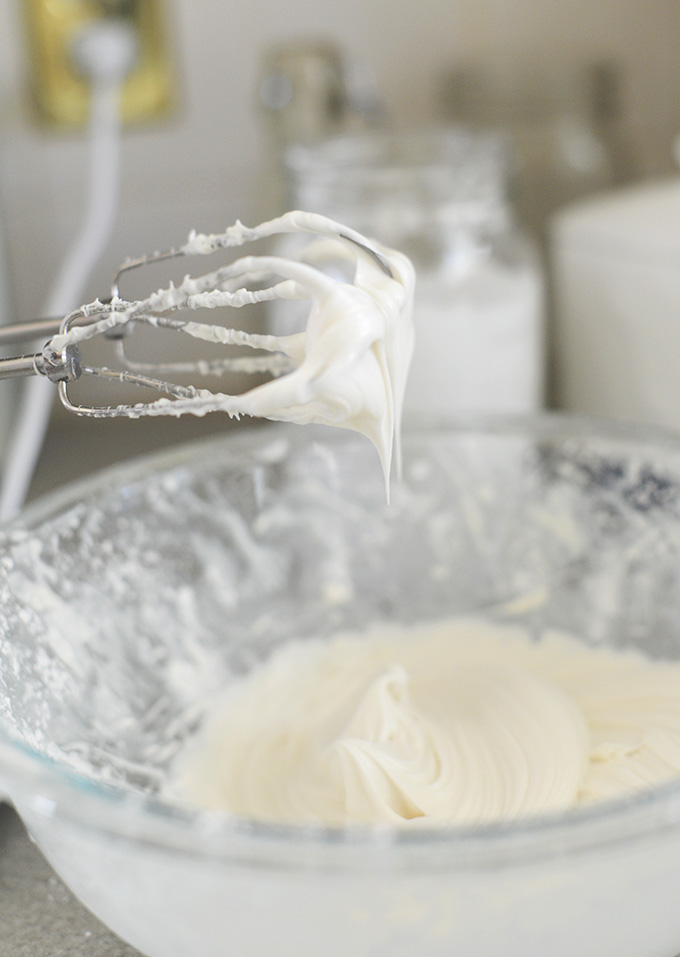 Dairy-Free Cream Cheese Filling dripping cascading off hand mixer into bowl