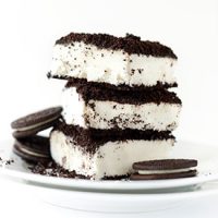 Slices of Vegan Dirt Cake on a small plate with three oreo cookies