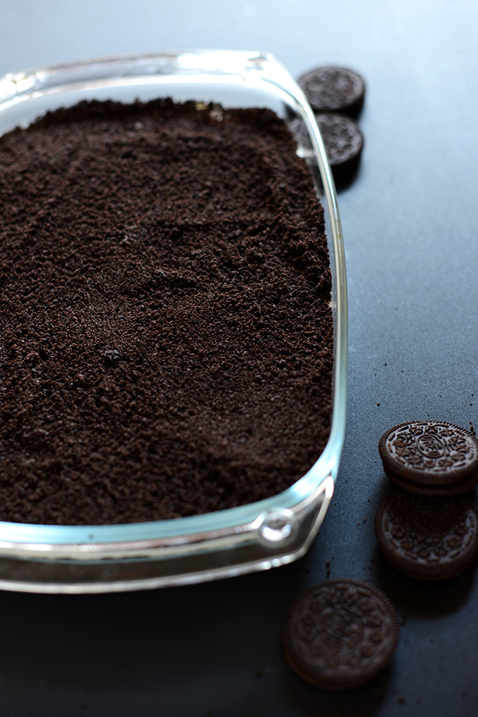 Baking pan filled with crushed Oreo Cookies for our Vegan Dirt Cake crust
