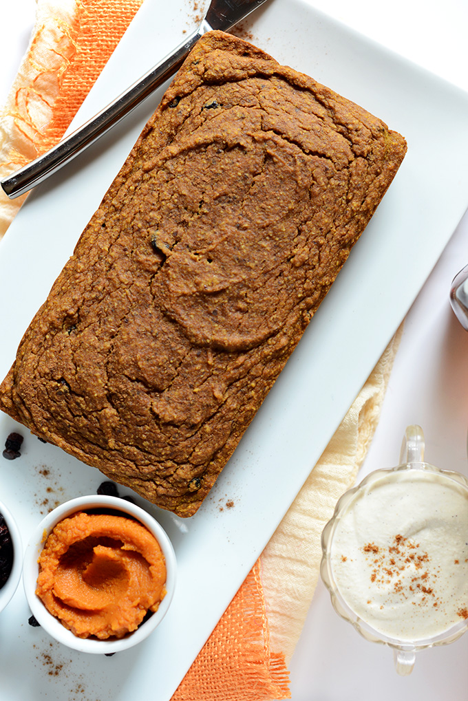 Plate with a loaf of Vegan Pumpkin Bread and a bowl of frosting