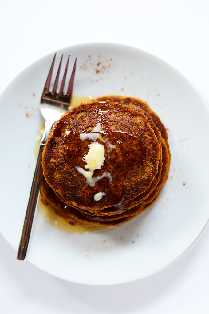 Top down shot of Pumpkin Spice Pancakes with vegan butter and syrup on top