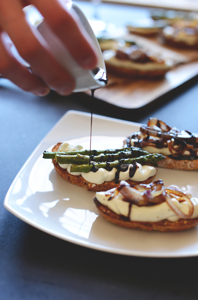 Drizzling balsamic reduction over Bleu Cheese Bites