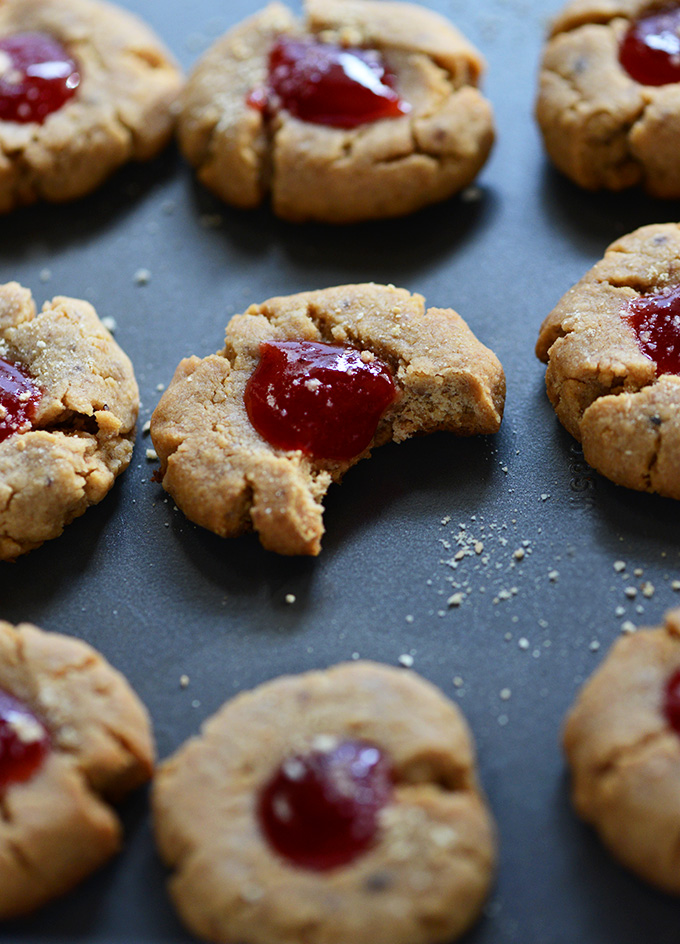 Batch of Vegan PB&J Thumbprint Cookies on a dark background