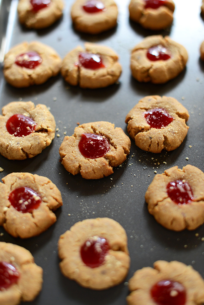 Baking sheet filled with homemade Vegan PB&J Graham Thumbprint Cookies