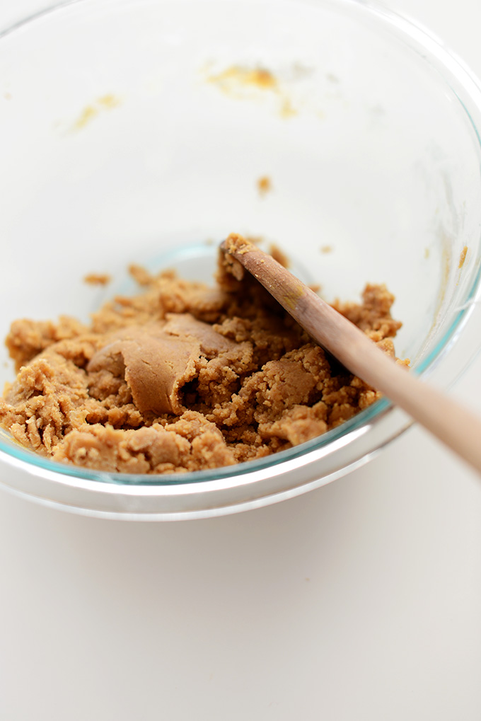 Using a wooden spoon to stir Vegan Peanut Butter Cookie Dough