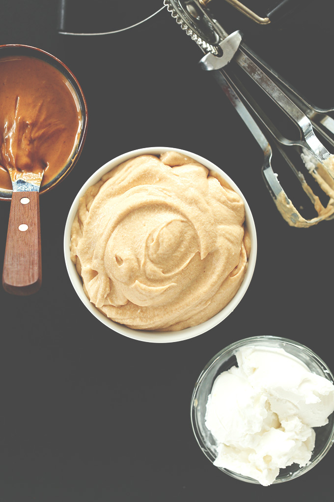 Bowl of Peanut Butter Mousse/Frosting surrounded by coconut cream and peanut butter
