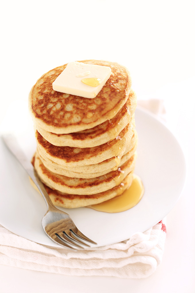 Stack of Fluffy Gluten-Free Pancakes topped with syrup and vegan butter