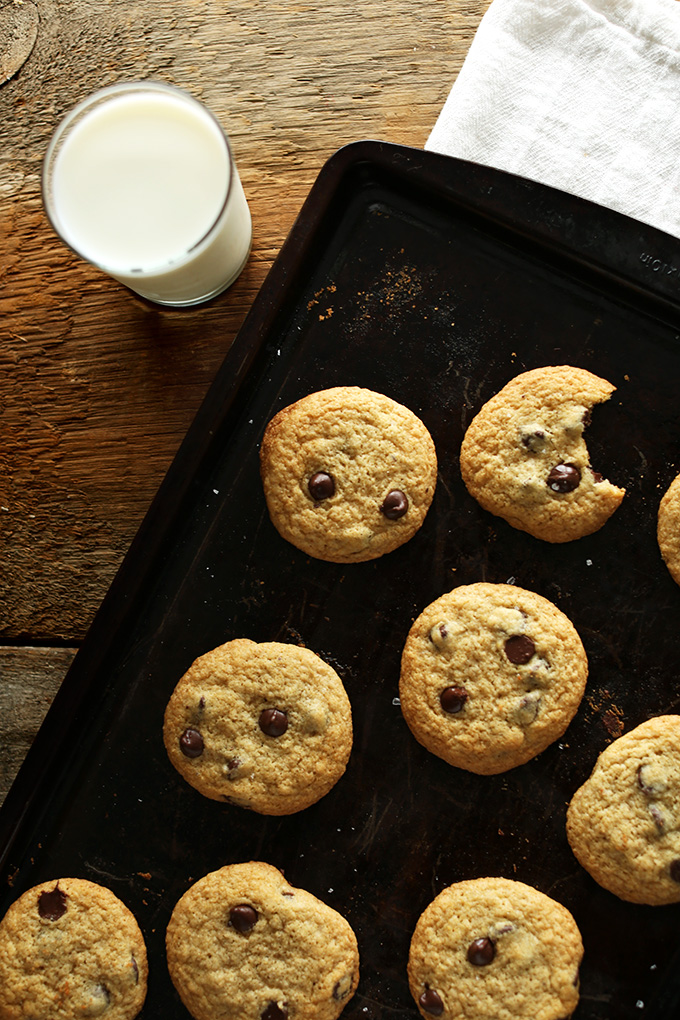 Batch of freshly baked GF Chocolate Chip Cookies and a glass of almond milk
