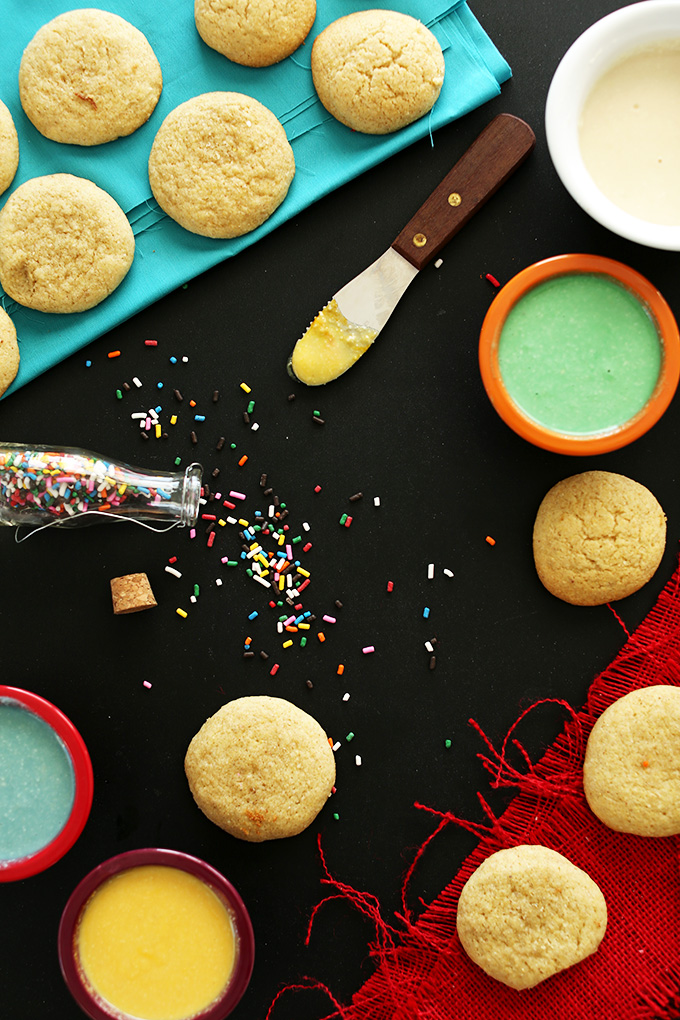 Plain sugar cookies and bowls of healthy homemade frosting for decorating