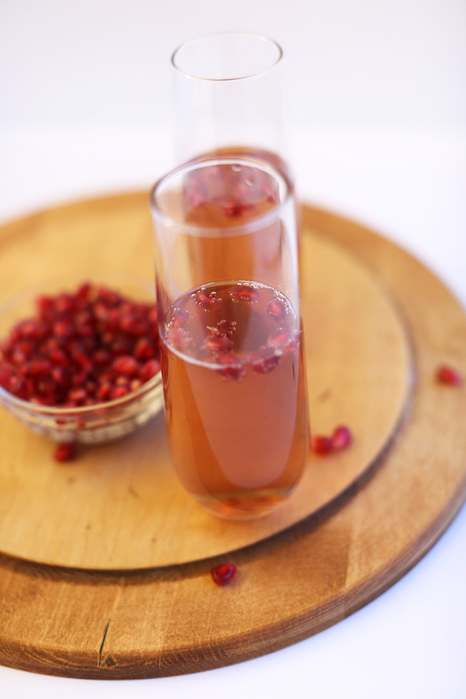 Cutting board with glasses of homemade St. Germain Champagne Pomegranate Spritzers