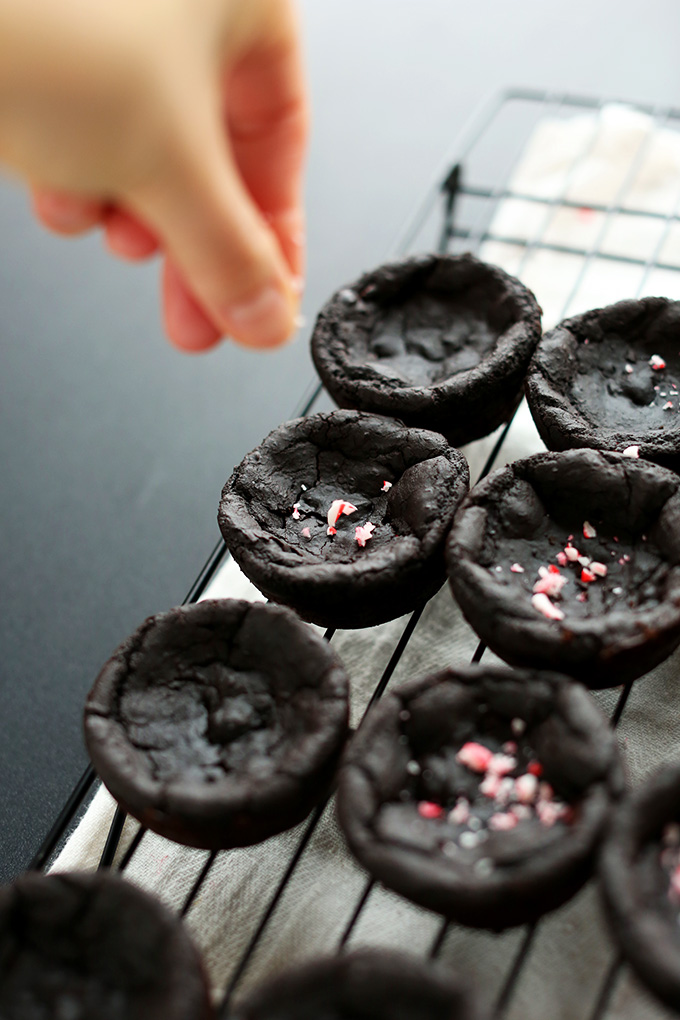 Sprinkling crushed candy canes onto Vegan Black Bean Brownies