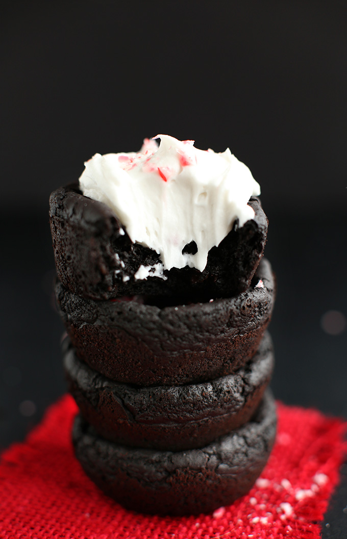 Stack of Vegan Peppermint Brownies topped with coconut whipped cream and crushed candy cane