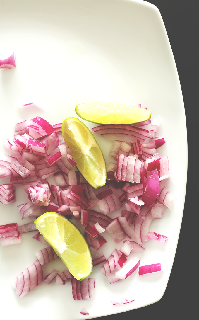 Plate of limes and red onion for garnishing Vegan Veggie Nacho Soup