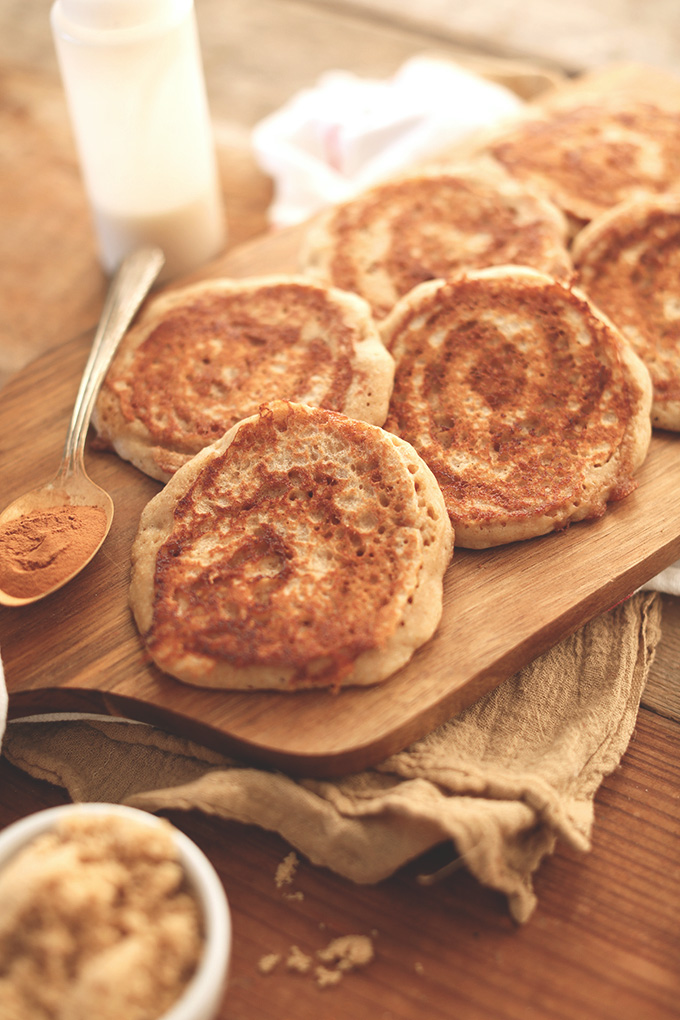 Cutting board with a freshly cooked batch of Vegan Yeasted Cinnamon Roll Pancakes