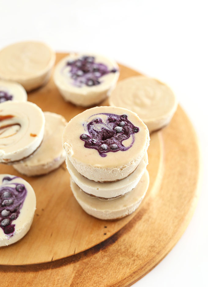 Cutting board filled with delicious Vegan Mini Cheesecakes made with blueberries and caramel