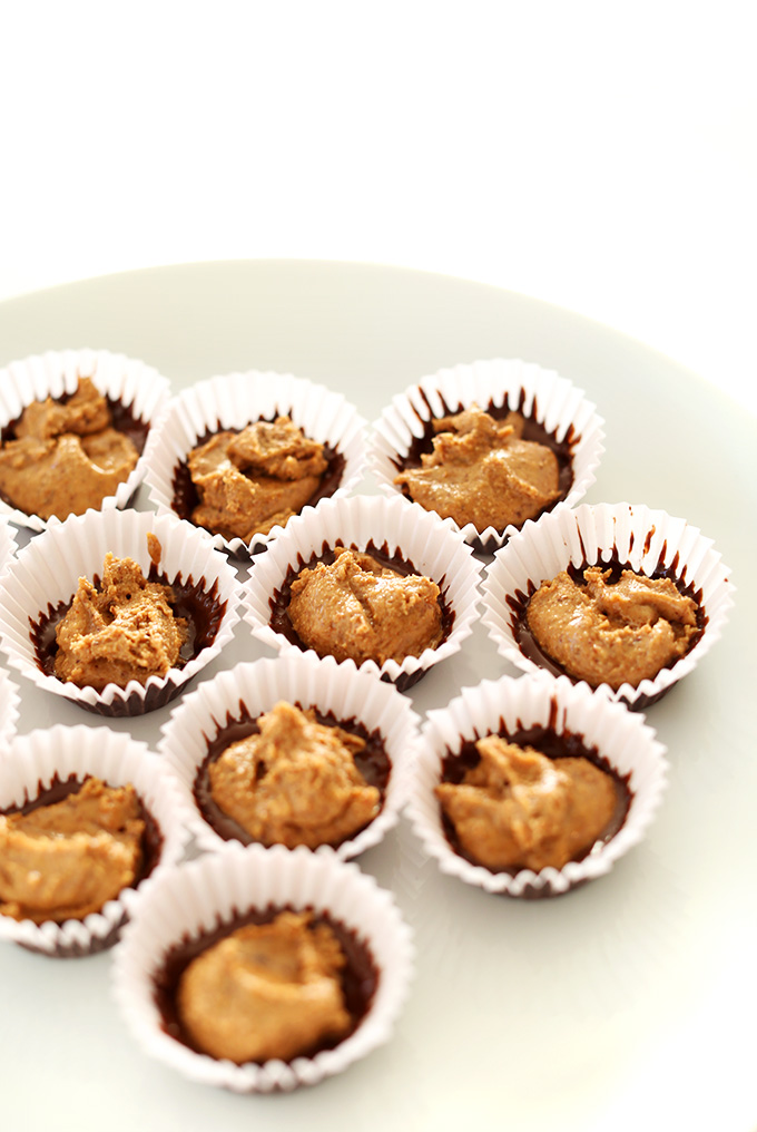 Showing the first chocolate layer and almond butter layer of homemade Almond Butter Cups