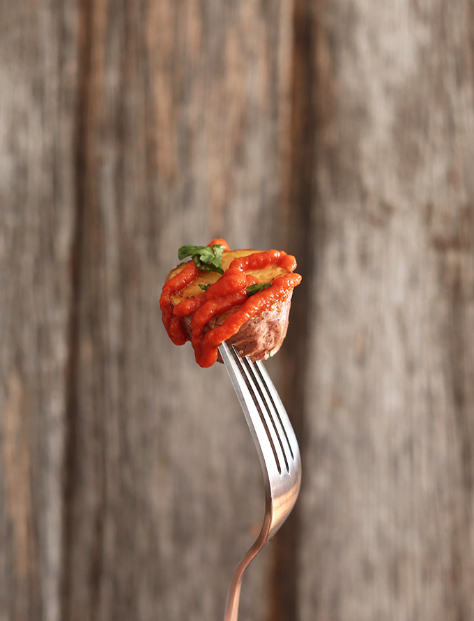 Holding up a bite of the Best Patatas Bravas