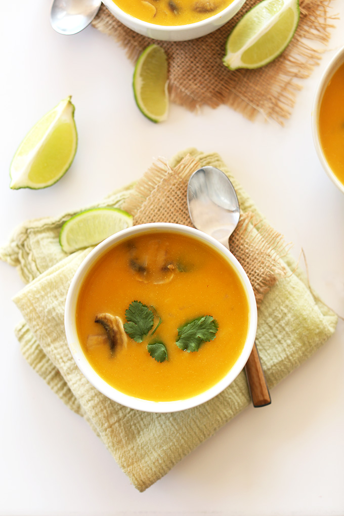 Bowl of Butternut Squash Tom Kha Gai soup topped with fresh basil