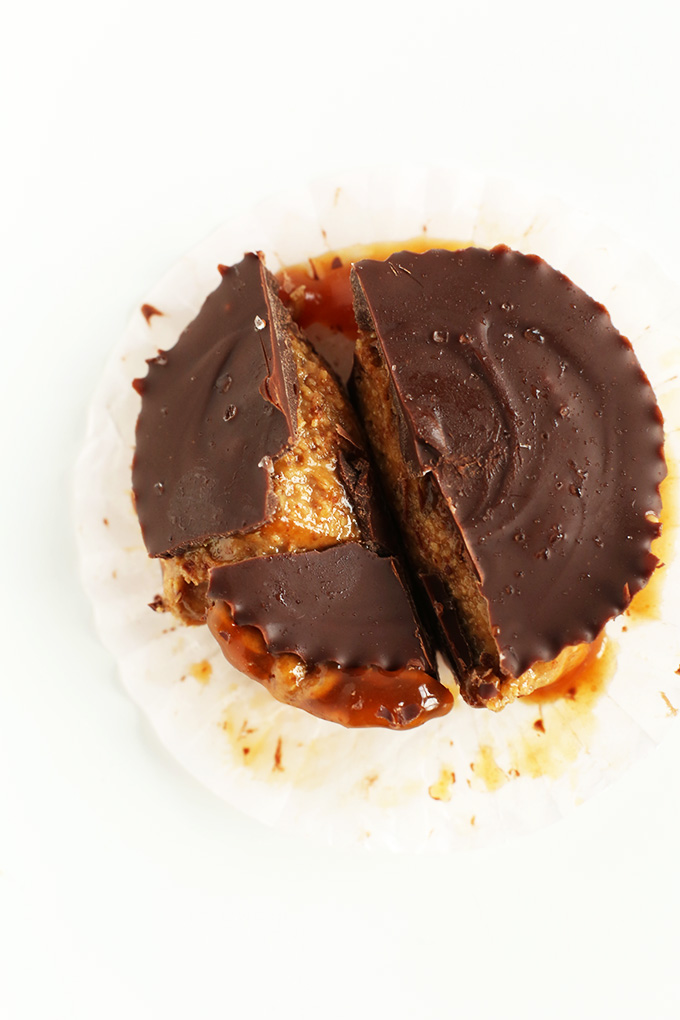 Sliced open Caramel Almond Butter Cup in a parchment muffin liner