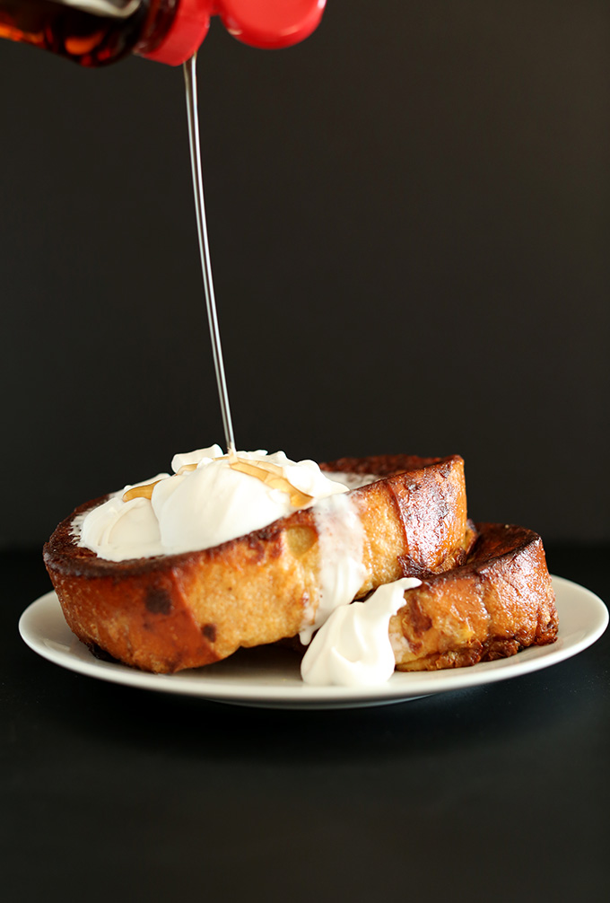 Drizzling syrup onto slices of Coconut Cream Pie French Toast for a dairy-free breakfast