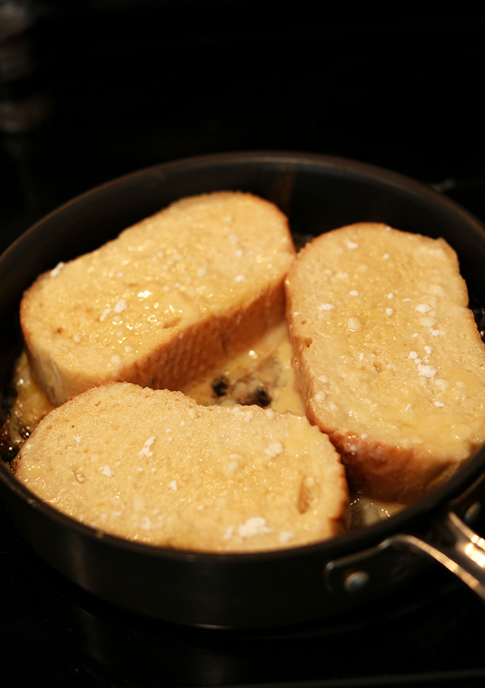 Cooking slices of Coconut Cream Pie French Toast in a skillet