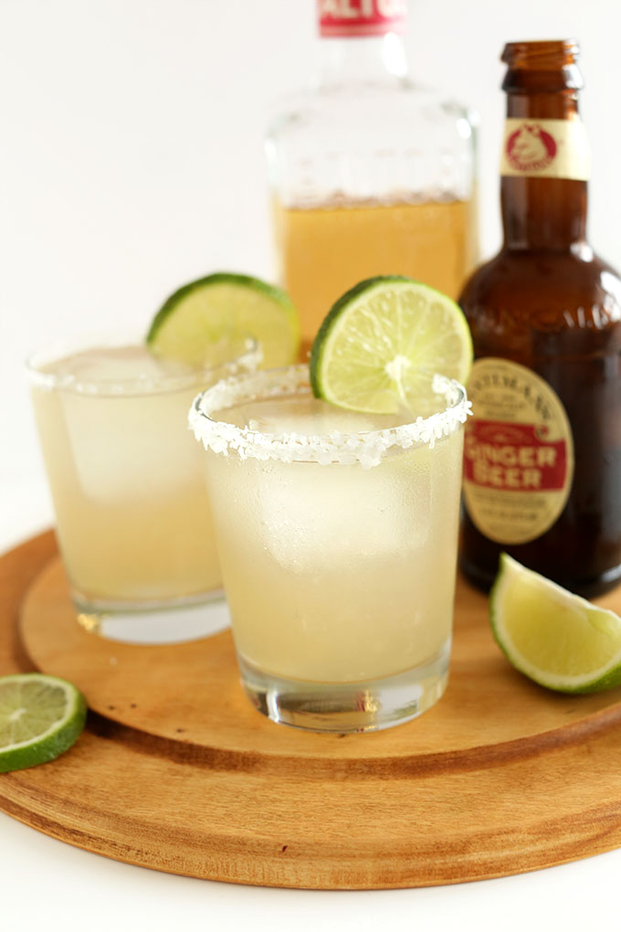 Two glasses of Ginger Beet Margaritas with salt and lime rims