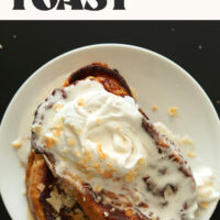 Plate stacked with sliced of our dairy-free Coconut Cream Pie French Toast