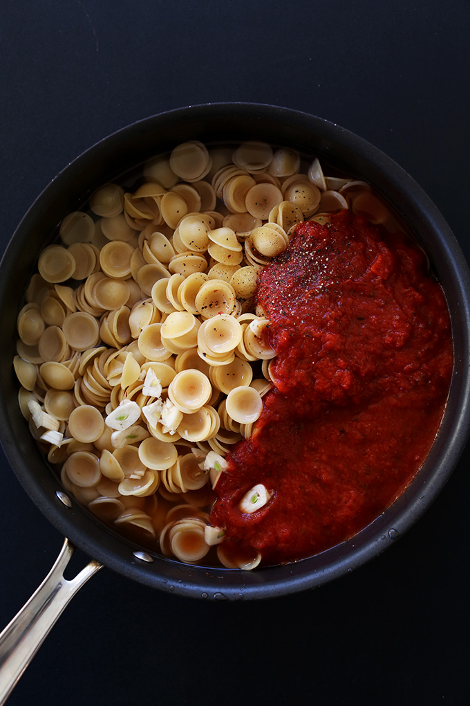 Skillet of orecchiette and tomato sauce for making a simple vegan pasta dish