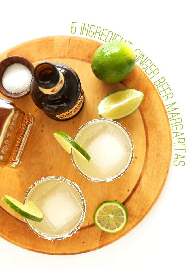 Cutting board with glasses of our Ginger Beer Margaritas with fresh lime slices