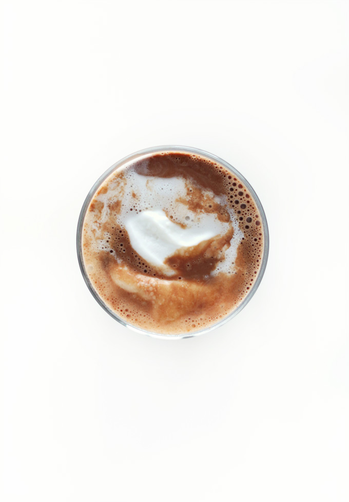 Glass of Vegan Hot Chocolate topped with coconut whipped cream
