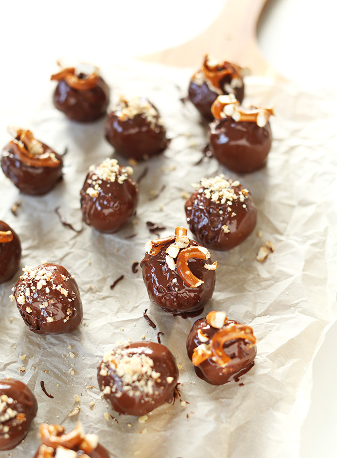Vegan Peanut Butter Pretzel Chocolate Truffles on a parchment-lined cutting board