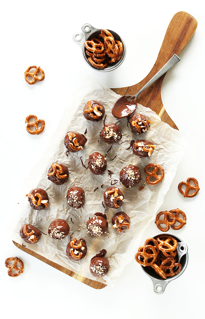 Parchment-lined cutting board filled with Vegan Peanut Butter Pretzel Truffles