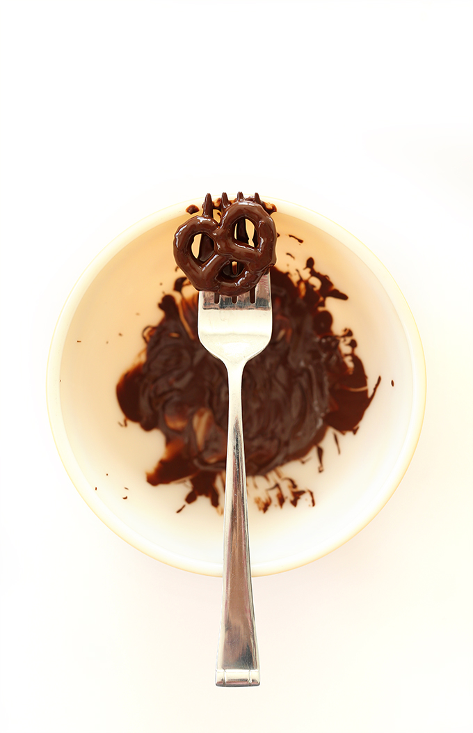 Using a fork to fold up a homemade Chocolate Covered Pretzel