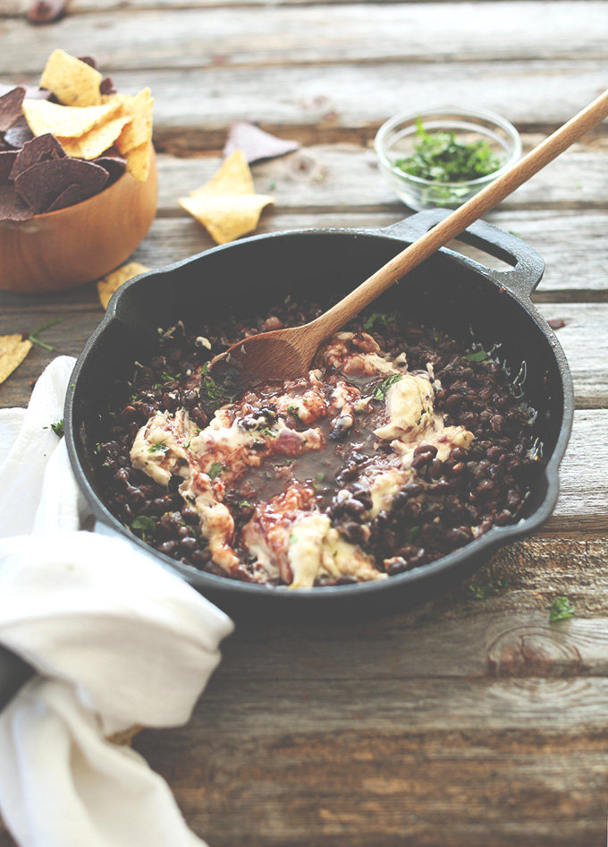 Skillet of Vegan Raspberry Chipotle Black Bean Dip alongside tortilla chips