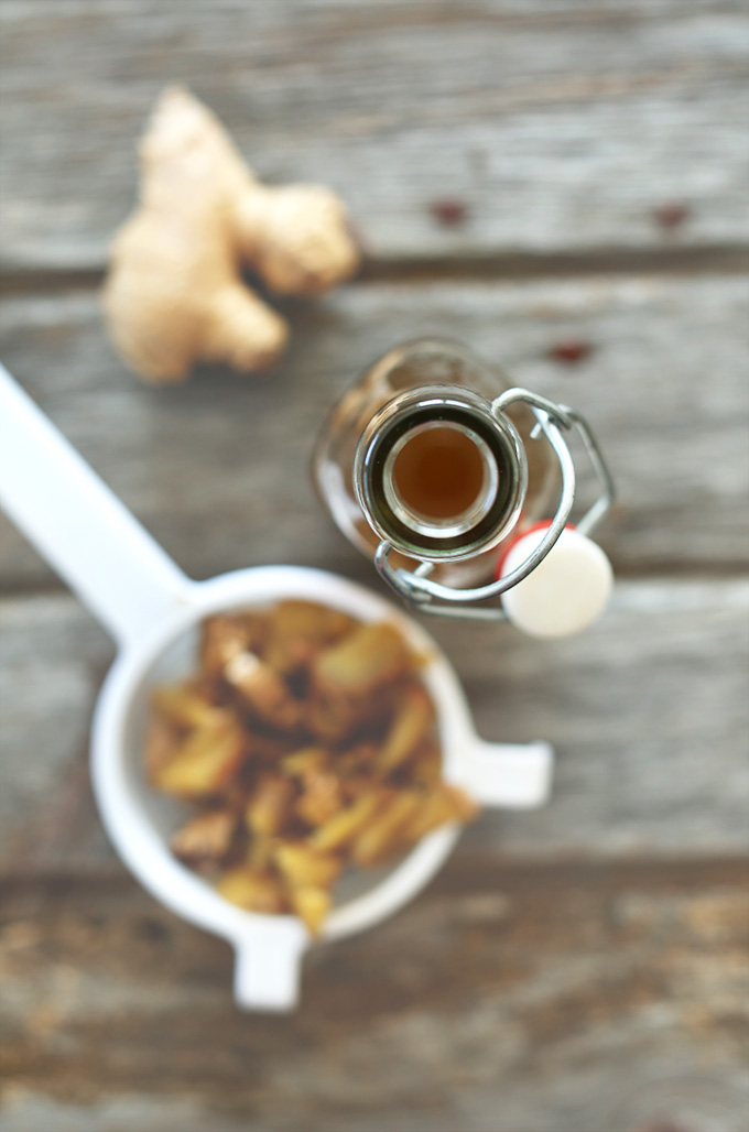 Blurred background and clear view of the top of a bottle of fresh ginger syrup