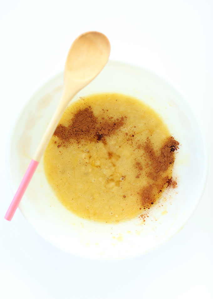 Bowl of gluten free banana bread batter topped with cinnamon