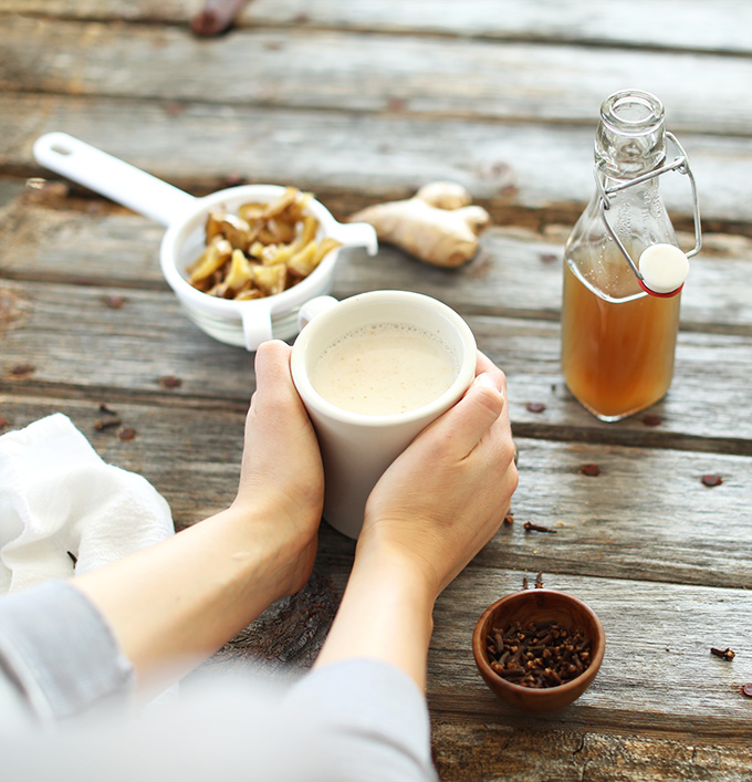 Warming my hands by holding a mug filled with a Homemade Ginger Tea Latte