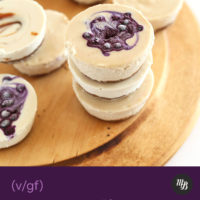 Cutting board with mini vegan cheesecakes with caramel and blueberries
