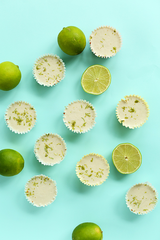 Mini Vegan Key Lime Pies surrounded by lime halves