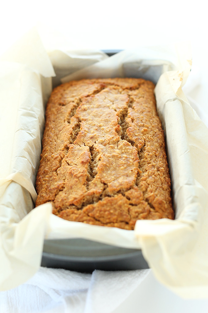 Parchment-lined loaf pan filled with a batch of Gluten Free Banana Bread