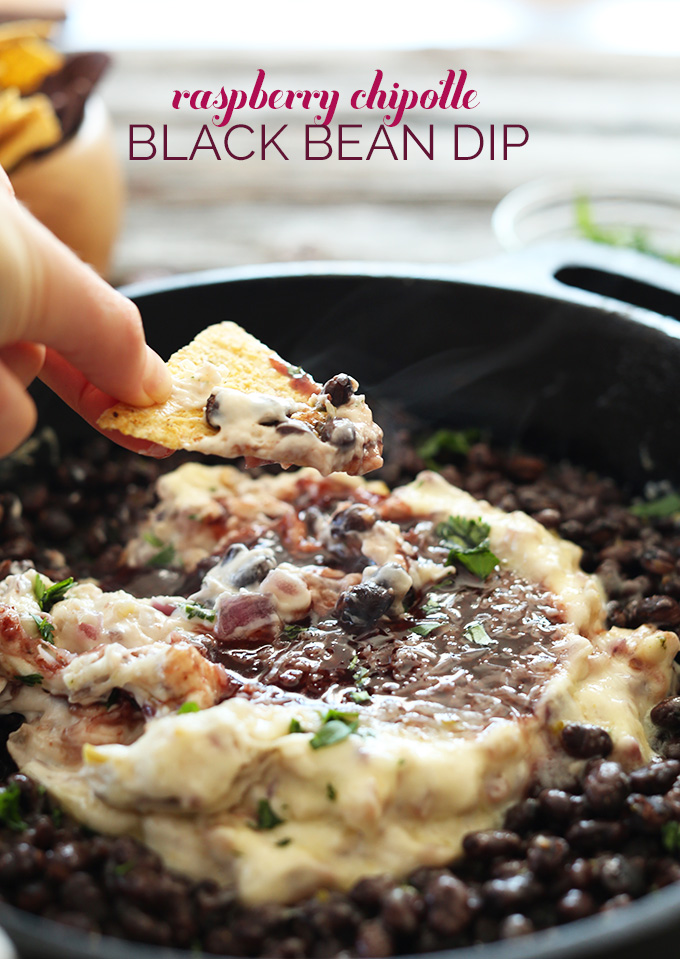 Grabbing a scoop of Vegan Raspberry Chipotle Black Bean Dip for game day