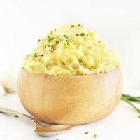 Wood bowl filled with a bowl of The Best Vegan Mashed Potatoes