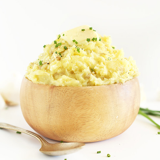 Wood bowl filled with a bowl of The Best Vegan Mashed Potatoes