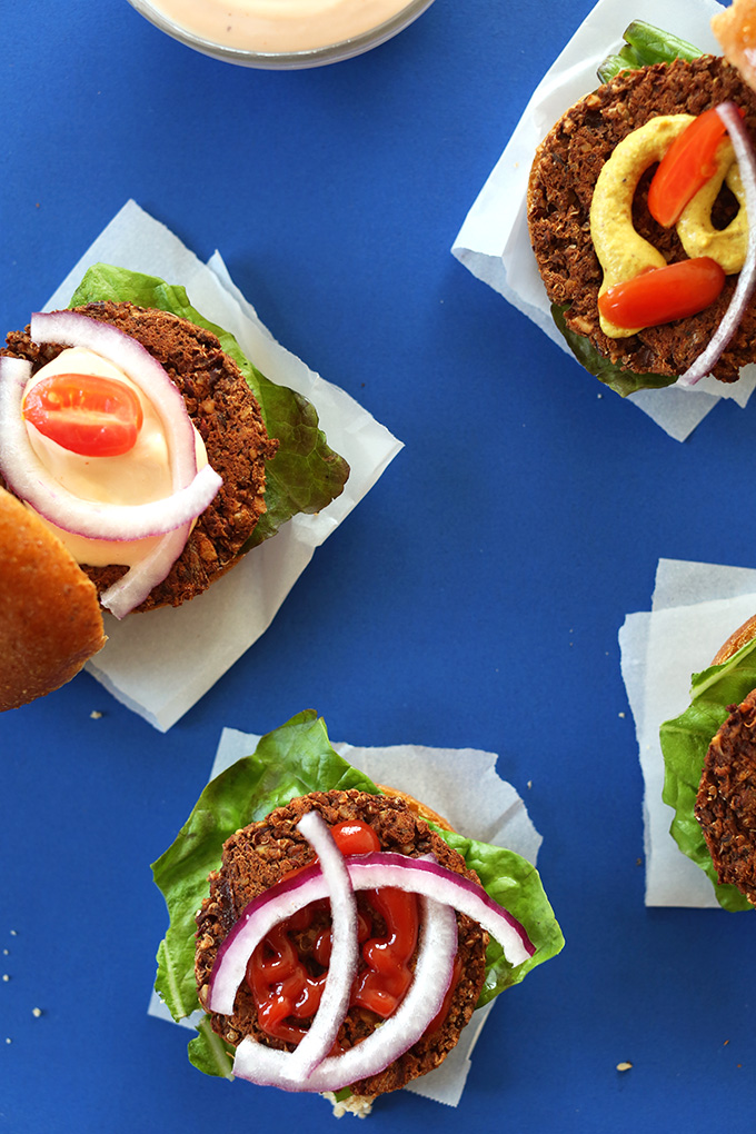 Smoky Veggie Sliders with mustard, vegan mayo, lettuce, tomato, and onion