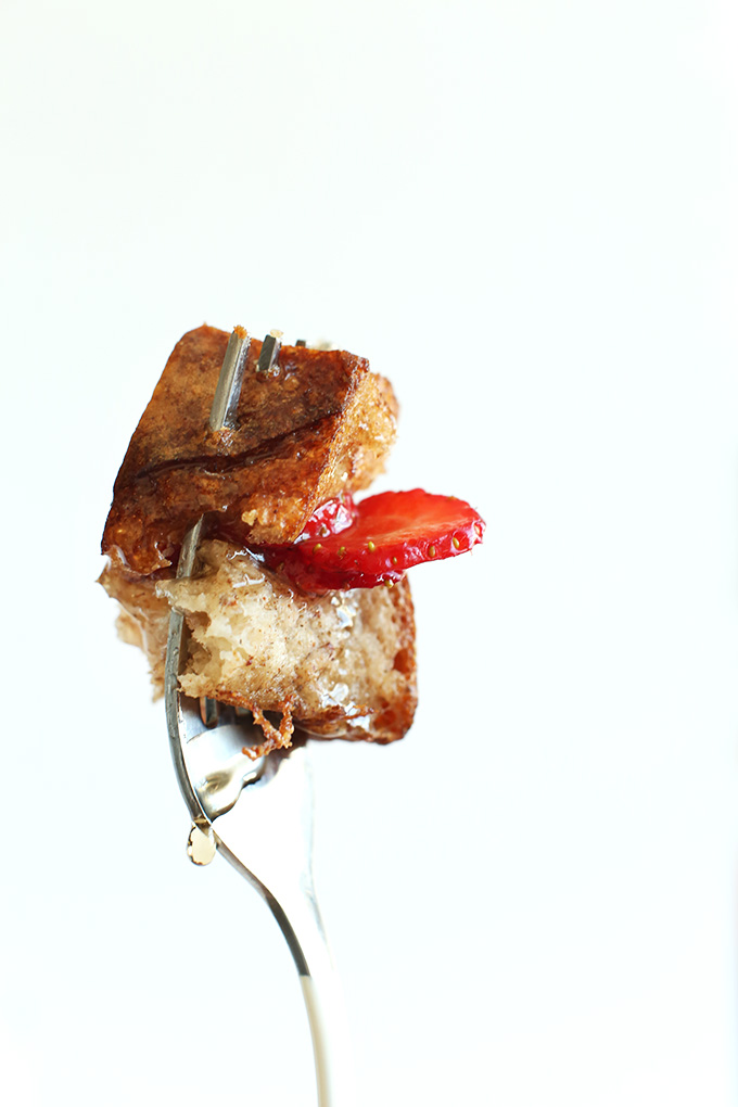 Holding up a fork with a bite of Vegan French Toast on it