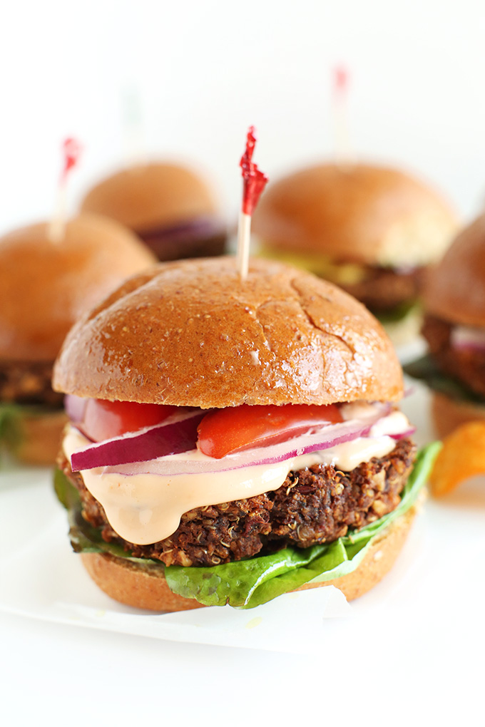 Wholesome Veggie Sliders on buns with tomato, red onion, and lettuce