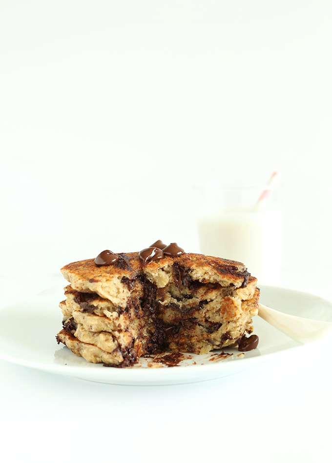 Partially eaten stack of gluten-free Oatmeal Cookie Pancakes topped with chocolate chips