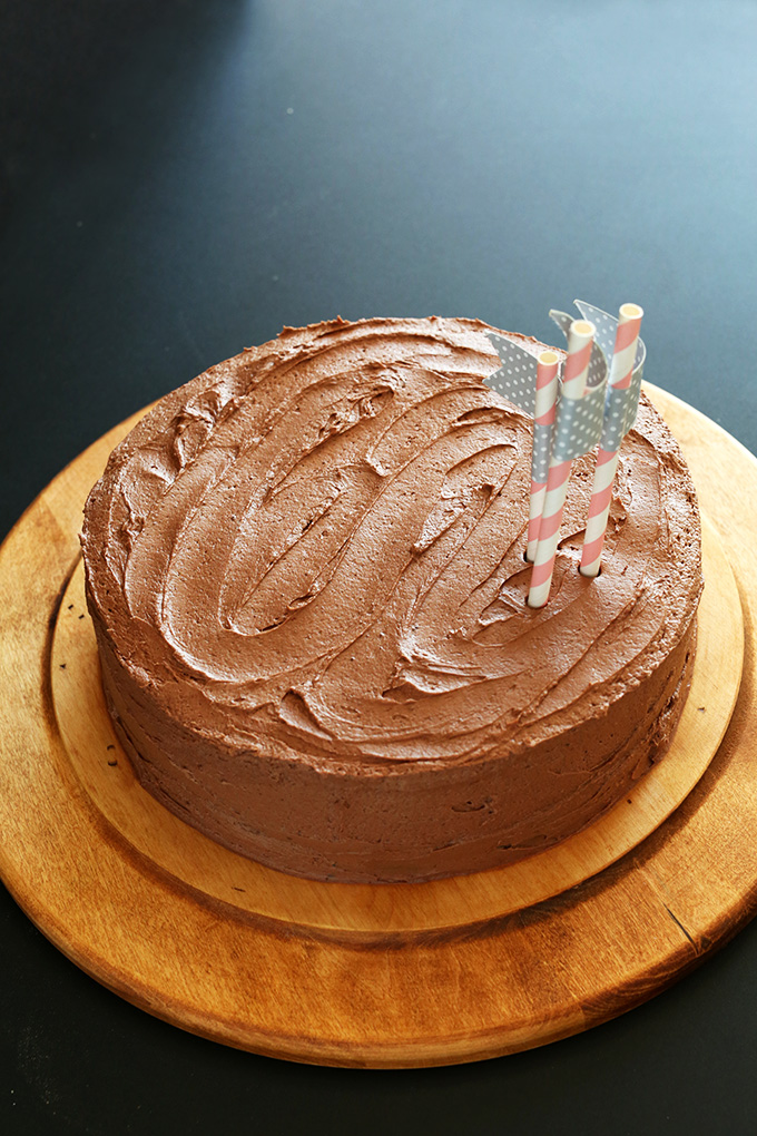 Frosted Vegan Chocolate Cake resting on a cutting board